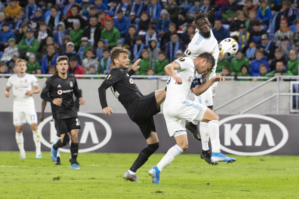 Besiktas Adem Ljajič, center, battles Slovan Bratislava Vasil Bozikov, right bottom and Myenty Abena  during a  Europa League group K soccer match between Slovan Bratislava and Besiktas Brick Field in Bratislava, Slovakia, Thursday, Sept. 19, 2019. (Pavel Neubauer/TASR via AP)