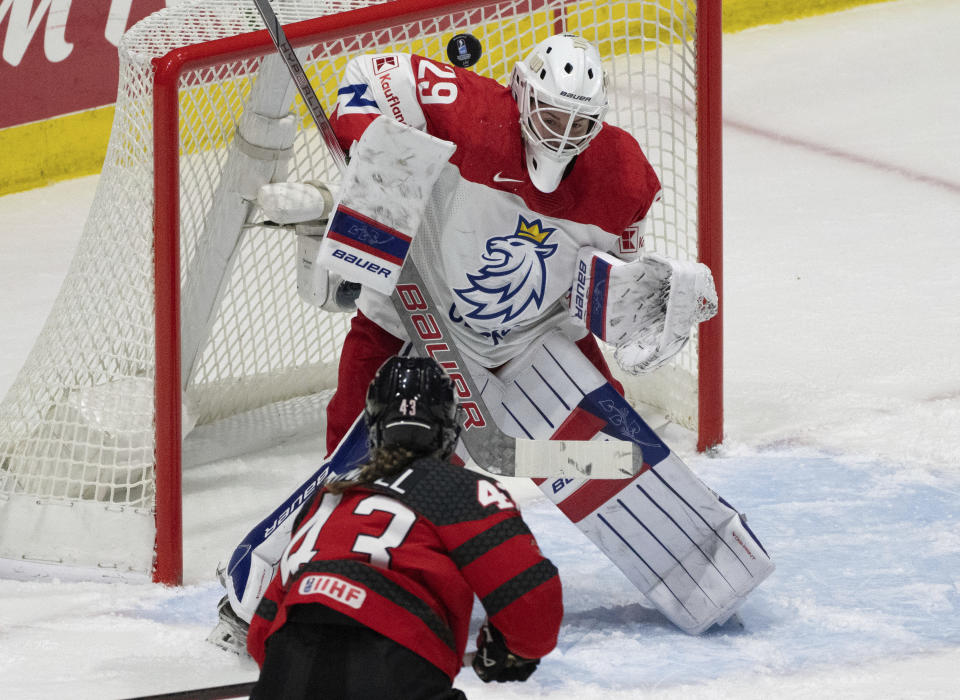 Canada's Kristin O'Neill (43) takes a shot on Czechia goaltender Klara Peslarova (29) during the first period of a hockey match at the IIHF Women's World Championships in Utica, N.Y., Sunday, April 7, 2024.(Christinne Muschi/The Canadian Press via AP)