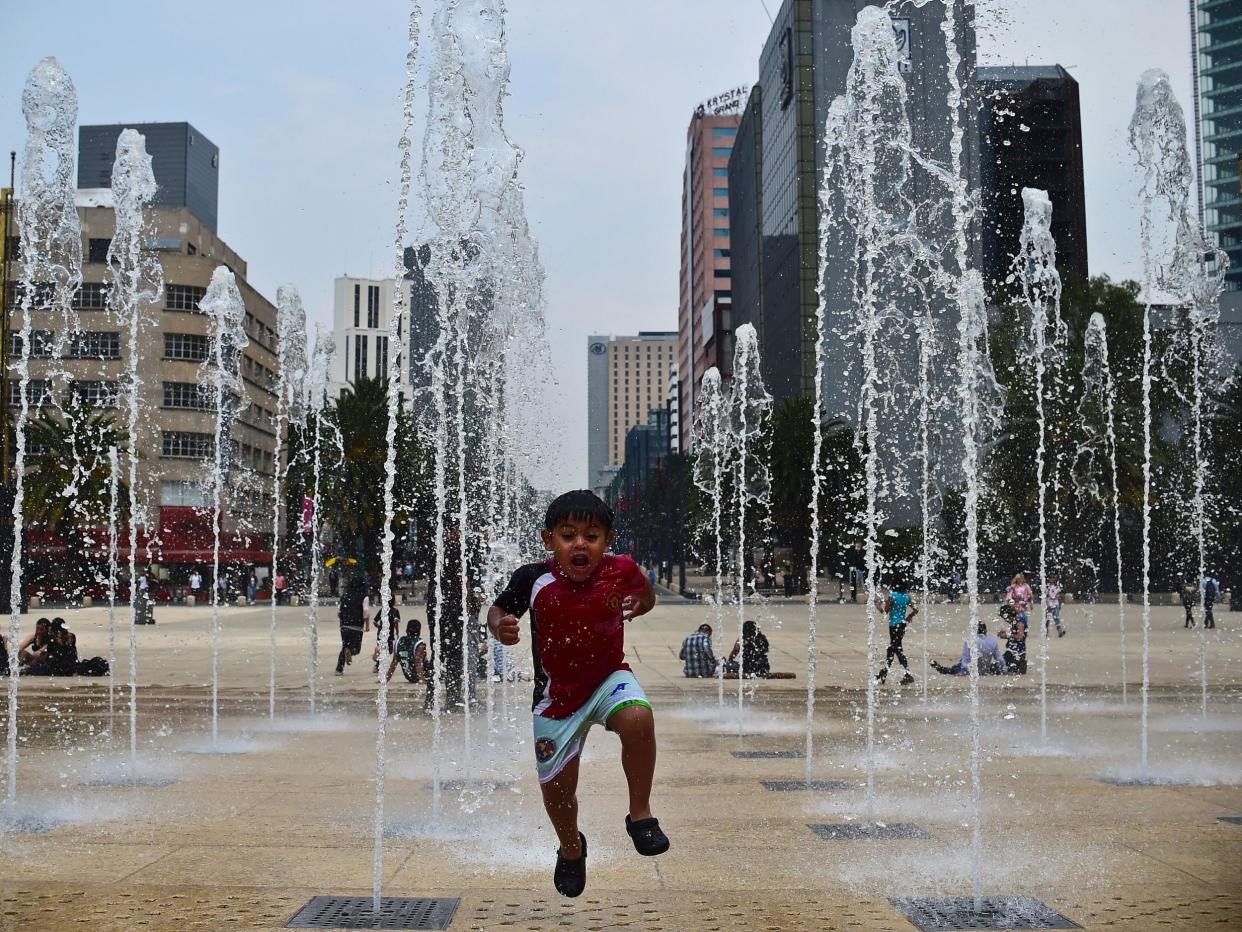 A boy plays in a fountain in Mexico City: Getty Images