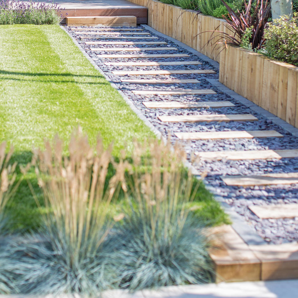 Striped garden lawn with gravel path and garden edging