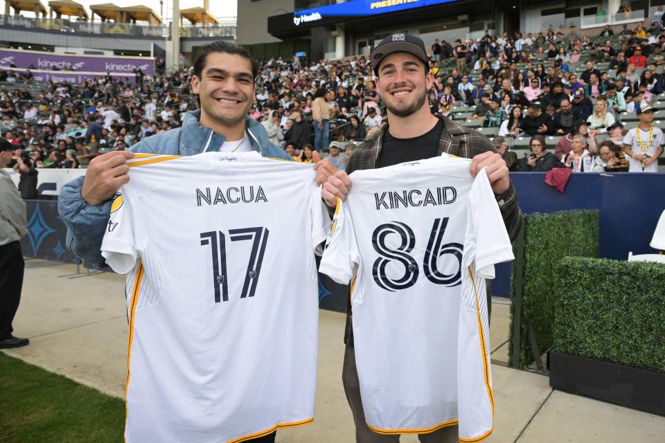 The Los Angeles Rams' Puka Nacua and Buffalo Bills' Dalton Kincaid pose with personalized L.A. Galaxy jerseys before the game against Inter Miami.