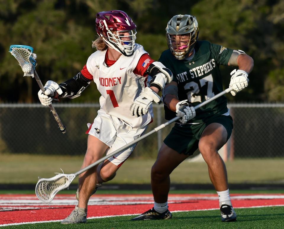Cardinal Mooney's (1) Sean Laureano holds his own against Saint Stephen's Ivan Tulupov (27) during the Class 1A-Region 3 quarterfinal at John Heath Field at Austin Smithers Stadium in Sarasota on Wednesday night, April, 20, 2022.