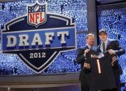 Boise State defensive end Shea McClellin, right, poses for photographs with NFL Commissioner Roger Goodell after being selected 19th overall by the Chicago Bears in the first round of the NFL football draft at Radio City Music Hall, Thursday, April 26, 2012, in New York. (AP Photo/Jason DeCrow)