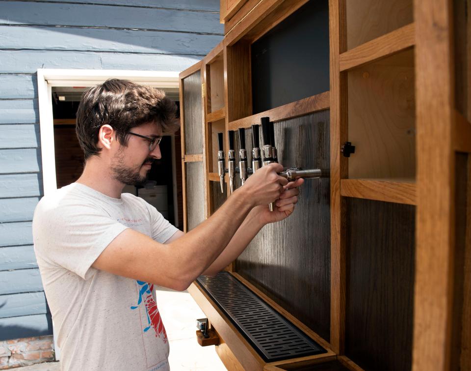 Jitterbug Beverage Co. co-owner Barrett Colhoun assembles a beverage dispensing system on the company's mobile unit built on a 1923 Ford Model T truck platform.