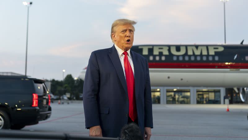 Former President Donald Trump speaks with reporters before departure from Hartsfield-Jackson Atlanta International Airport, Thursday, Aug. 24, 2023, in Atlanta. Trump has pleaded not guilty and waived arraignment in the case accusing him and others of illegally trying to overturn the results of the 2020 election in Georgia.