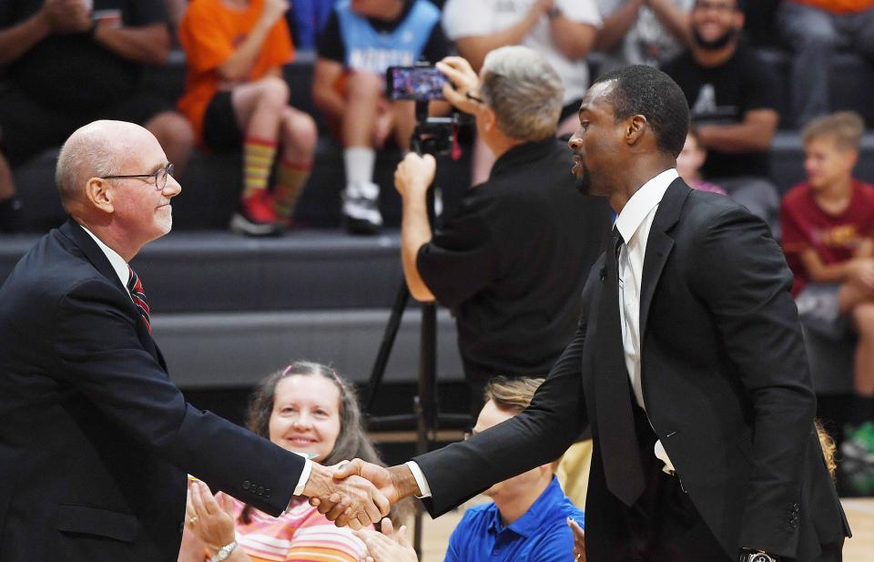 Former Ames High basketball player and NBA star Harrison Barnes is congratulated by Ames mayor John Haila after a proclamation of u0022Harrison Barnes Dayu0022 during the Ames High School's new Harrison Barnes Gymnasium and Court dedication ceremony at the school Thursday.