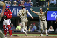 San Diego Padres' Wil Myers (5) scores against the Texas Rangers during the first inning of a baseball game Friday, April 9, 2021, in Arlington, Texas. (AP Photo/Richard W. Rodriguez)