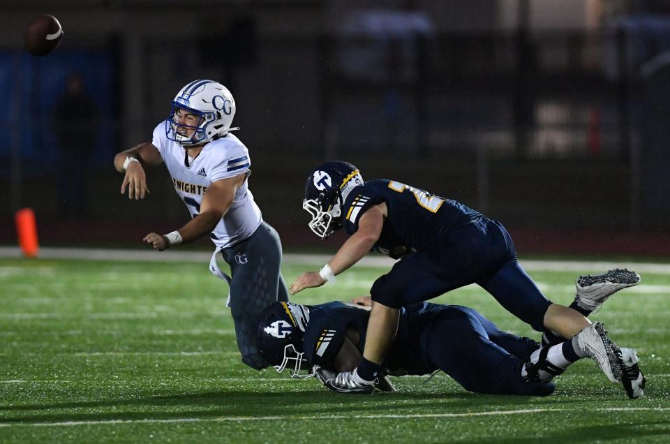 O'Gorman's Bennett Dannenbring is sacked by Tea Area's Nike Rosas and Matt Halbur during a football game on Friday, September 9, 2022, in Tea.