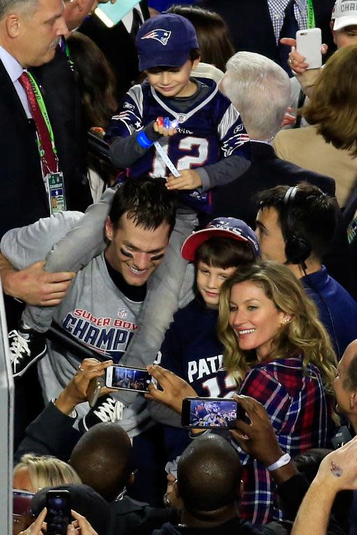 Tom Brady of the New England Patriots celebrates defeating the Seattle Seahawks with his wife Gisele Bundchen and son Benjamin during Super Bowl XLIX at University of Phoenix Stadium on February 1, 2015