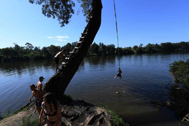 People escape 40-degree heat at a popular swimming hole on the Nepean River at Penrith in Western Sydney.