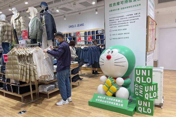 BEIJING, CHINA - NOVEMBER 06: Customers shop at a Uniqlo global flagship store on November 6, 2021 in Beijing, China. Uniqlo opens Beijing&#39;s first global flagship store on Saturday. (Photo by VCG/VCG via Getty Images)