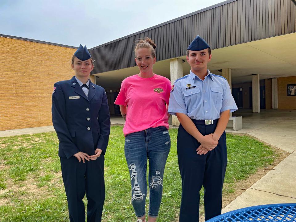 Cadet Amber Adams with event coordinator Colleen Plante and Cadet Nathan Schroeder take a break at the fourth annual Community Bazaar at Karns High School Saturday, April 30, 2022.