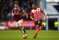 <p>Ryan Bertrand of Southampton (R) attempts to get away from George Boyd of Burnley</p>