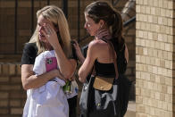 Women speak at the reunification center at the Woodmont Baptist church after school shooting, Monday, March 27, 2023, in Nashville, Tenn. (AP Photo/John Bazemore)