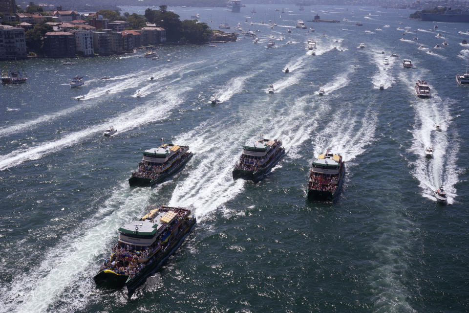 Pleasure craft follows ferries that are having an annual race on Sydney Harbour during Australia Day celebration in Sydney, Thursday, Jan. 26, 2023. Australia marks the anniversary of British colonists settling modern day Sydney in 1788 while Indigenous protesters deride Australia Day as Invasion Day. (AP Photo/Rick Rycroft)