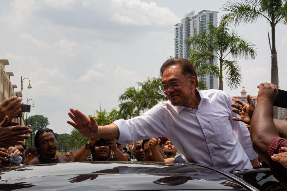 FILE PHOTO: Malaysian politician Anwar Ibrahim waves to his supporters outside the headquarter of People's Justice Party (PKR) on March 1, 2020 in Kuala Lumpur, Malaysia. (Photo by Ore Huiying/Getty Images)