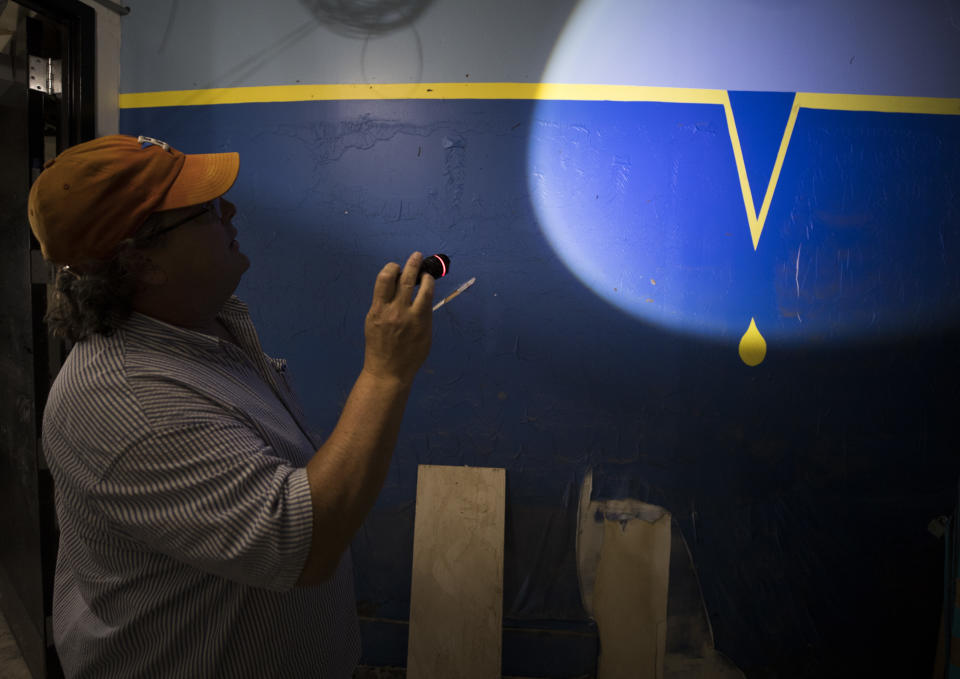 Alley Theatre general manager Ten Eyck Swackhamer shines his flashlight on the high-water mark from Tropical Storm Allison painted on a wall in the lower section of the theater that was flooded by Hurricane Harvey in Houston on Sept. 8, 2017. The high-water mark from Hurricane Harvey was about two feet above that. (Photo: Erich Schlegel for Yahoo News)