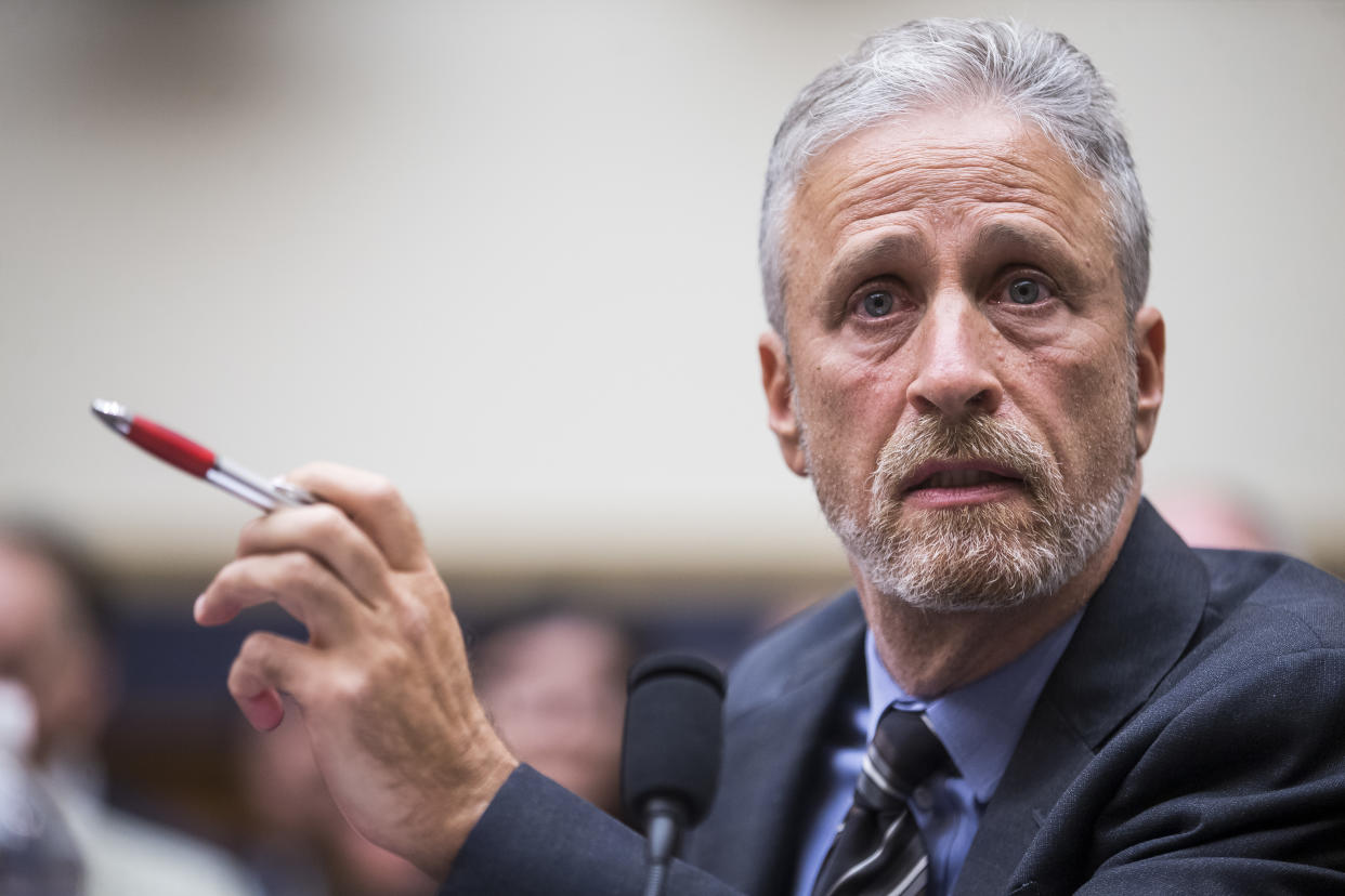 Jon Stewart, sitting at a microphone, testifies before Congress.