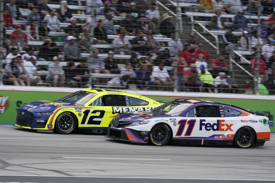 Denny Hamlin (11) and Ryan Blaney (12) drive during the NASCAR All-Star auto race at Texas Motor Speedway in Fort Worth, Texas, Sunday, May 22, 2022. (AP Photo/Larry Papke)