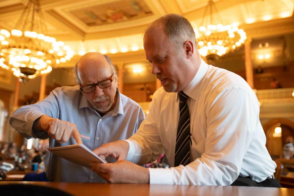 Rep. Tom Sawyer, D-Wichita, left, looks through Gov. Laura Kelly's vetoes with Rep. Adam Smith, R-Weskan, during a House veto session on Monday.