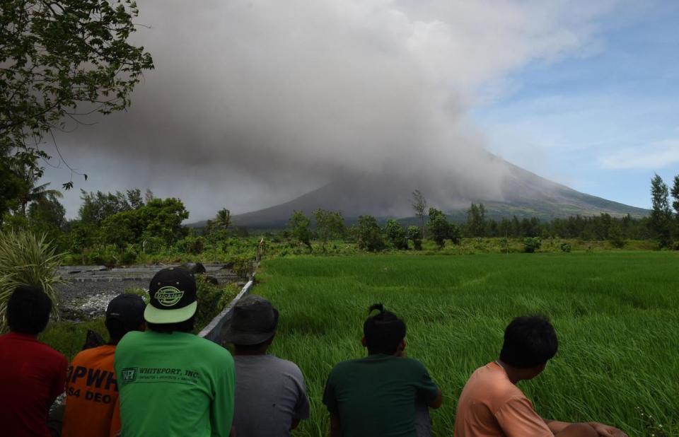 Residents of the Philippines look on as Mount Mayon spews ash (AFP/Getty Images)