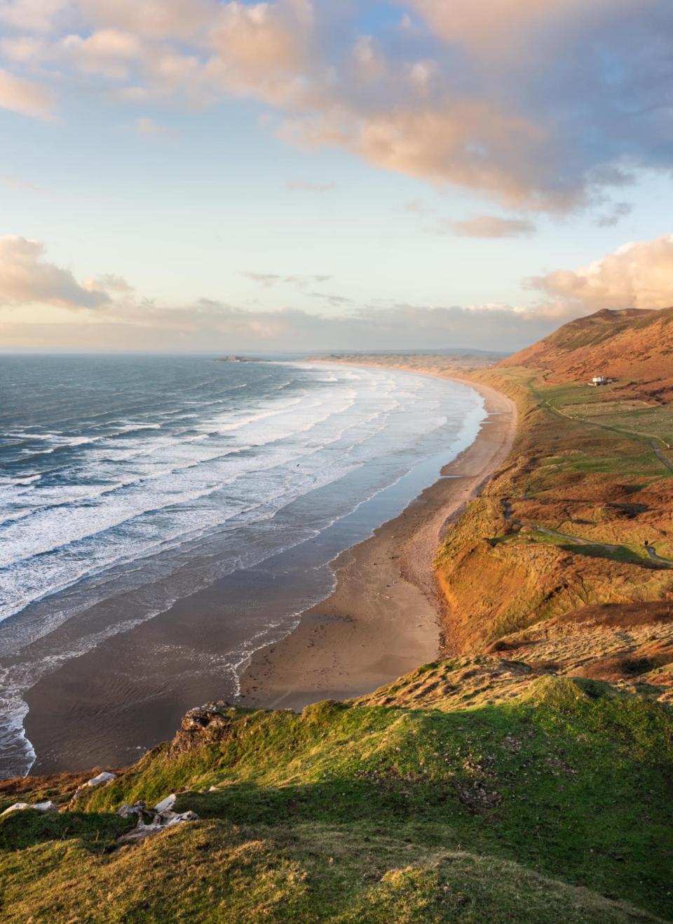 Photo of a coastal landscape bathed in a golden glow.