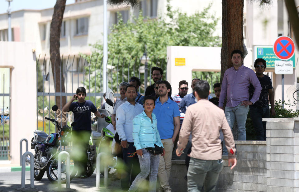 <p>People gather near the parliament’s building during a gunmen attack in central Tehran, Iran, June 7, 2017. (Photo: TIMA via Reuters) </p>