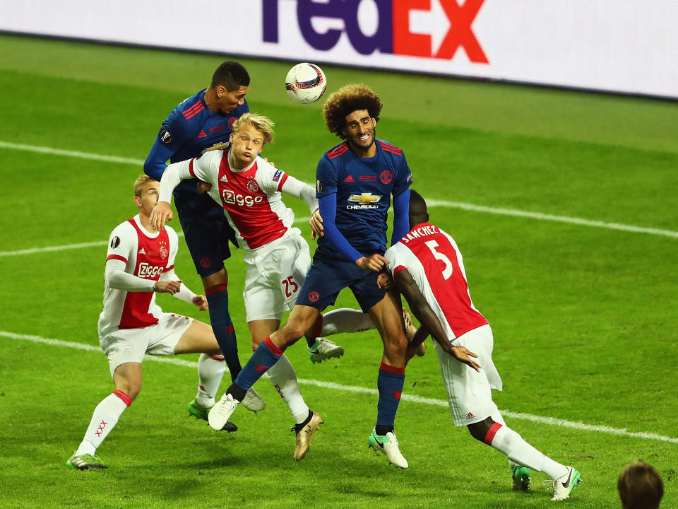 Chris Smalling and Marouane Fellaini in action for United: Getty