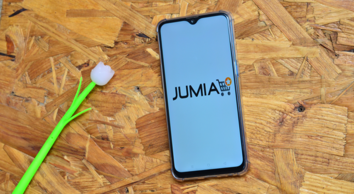 Jumia (JMIA) logo on a cellphone with a flower