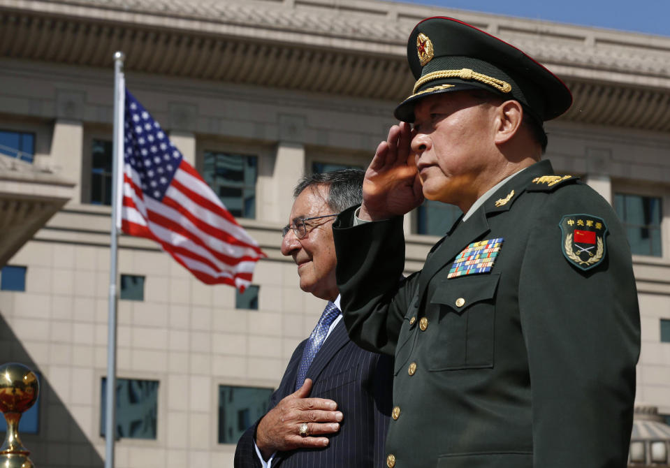 U.S. Defense Secretary Leon Panetta, left, stands at attention next to China's Defense Minister Liang Guanglie at the Bayi Building in Beijing, China Tuesday, Sept. 18, 2012. (AP Photo/Larry Downing, Pool)