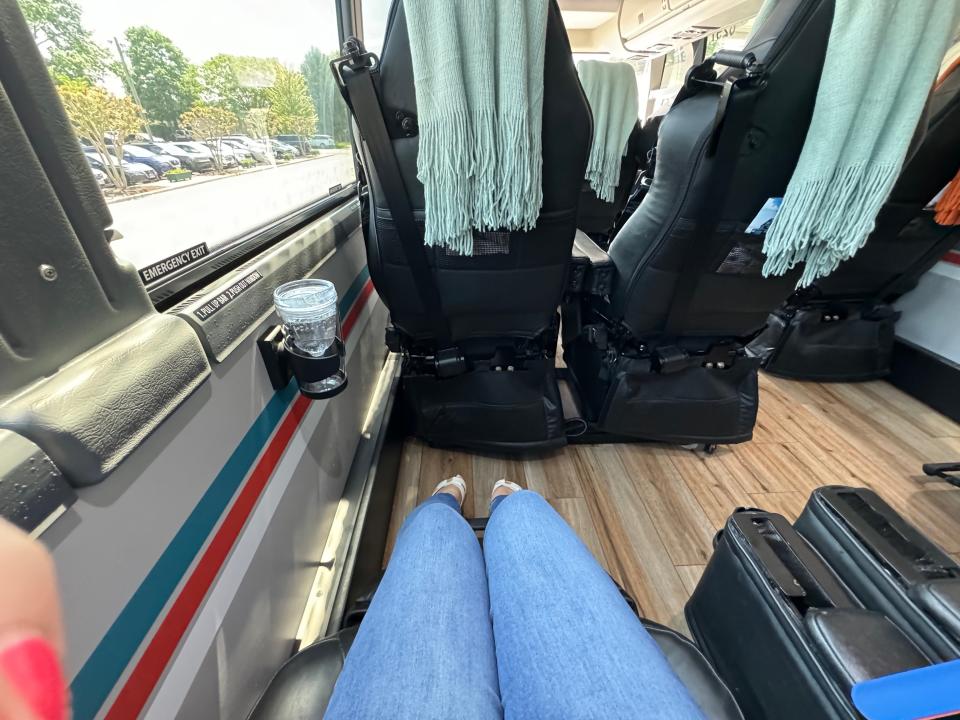 shot of someone's legs sitting in a comfy bus seat with lots of legroom