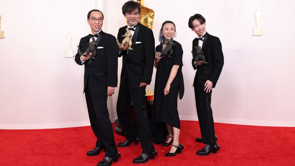 Winners of the Best Visual Effects award for "Godzilla Minus One," Masaki Takahashi, Takashi Yamazaki, Kiyoko Shibuya and Tatsuji Nojima matched in all-black ensembles. They all completed their looks with shoes featuring heels resembling Godzilla’s hands. - Christina House/Los Angeles Times/Getty Images