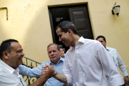 Venezuelan opposition leader Juan Guaido, who many nations have recognised as the country's rightful interim ruler, greets supporters after his visit to La Chiquinquira church in Maracaibo, Venezuela, April 13, 2019. REUTERS/Ueslei Marcelino