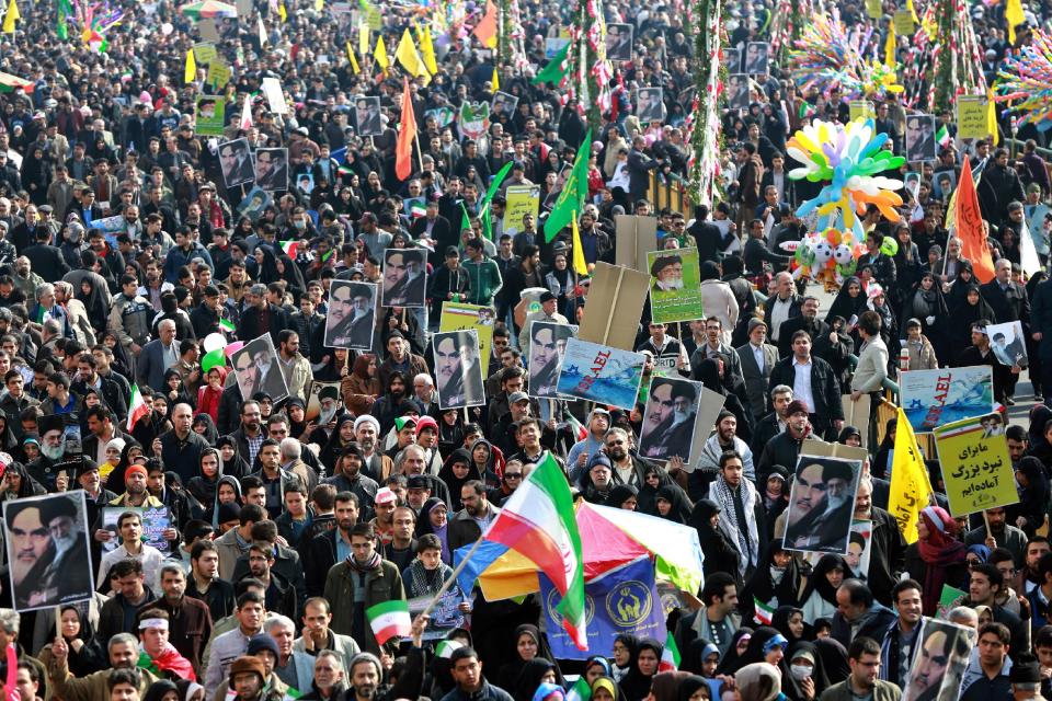 Iranian chant slogans during an annual rally commemorating the anniversary of the 1979 Islamic revolution in Tehran, Iran, Tuesday, Feb. 11, 2014. Tuesday marks the 35th anniversary of the revolution that toppled the pro-U.S. Shah Mohammad Reza Pahlavi and brought Islamists to power. (AP Photo/Ebrahim Noroozi)