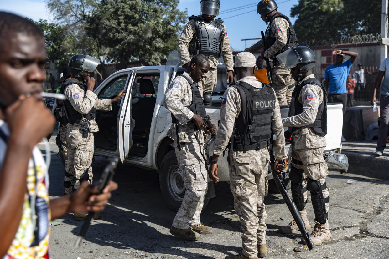 Haitian police officers load their riot guns before firing tear gas canisters toward the groups of protesters who were marching toward the U.S. Embassy. (Photo by Adam DelGiudice/SOPA Images/LightRocket via Getty Images)