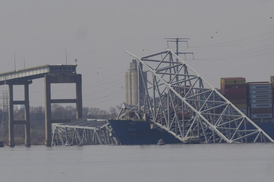 A container ship rests against wreckage of the Francis Scott Key Bridge on Tuesday, March 26, 2024, as seen from Sparrows Point, Md. The ship rammed into the major bridge in Baltimore early Tuesday, causing it to collapse in a matter of seconds and creating a terrifying scene as several vehicles plunged into the chilly river below. (AP Photo/Matt Rourke)