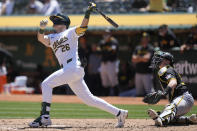 Oakland Athletics' Tyler Nevin (26) watches his home run in front of Pittsburgh Pirates catcher Henry Davis during the third inning of a baseball game in Oakland, Calif., Wednesday, May 1, 2024. (AP Photo/Jeff Chiu)