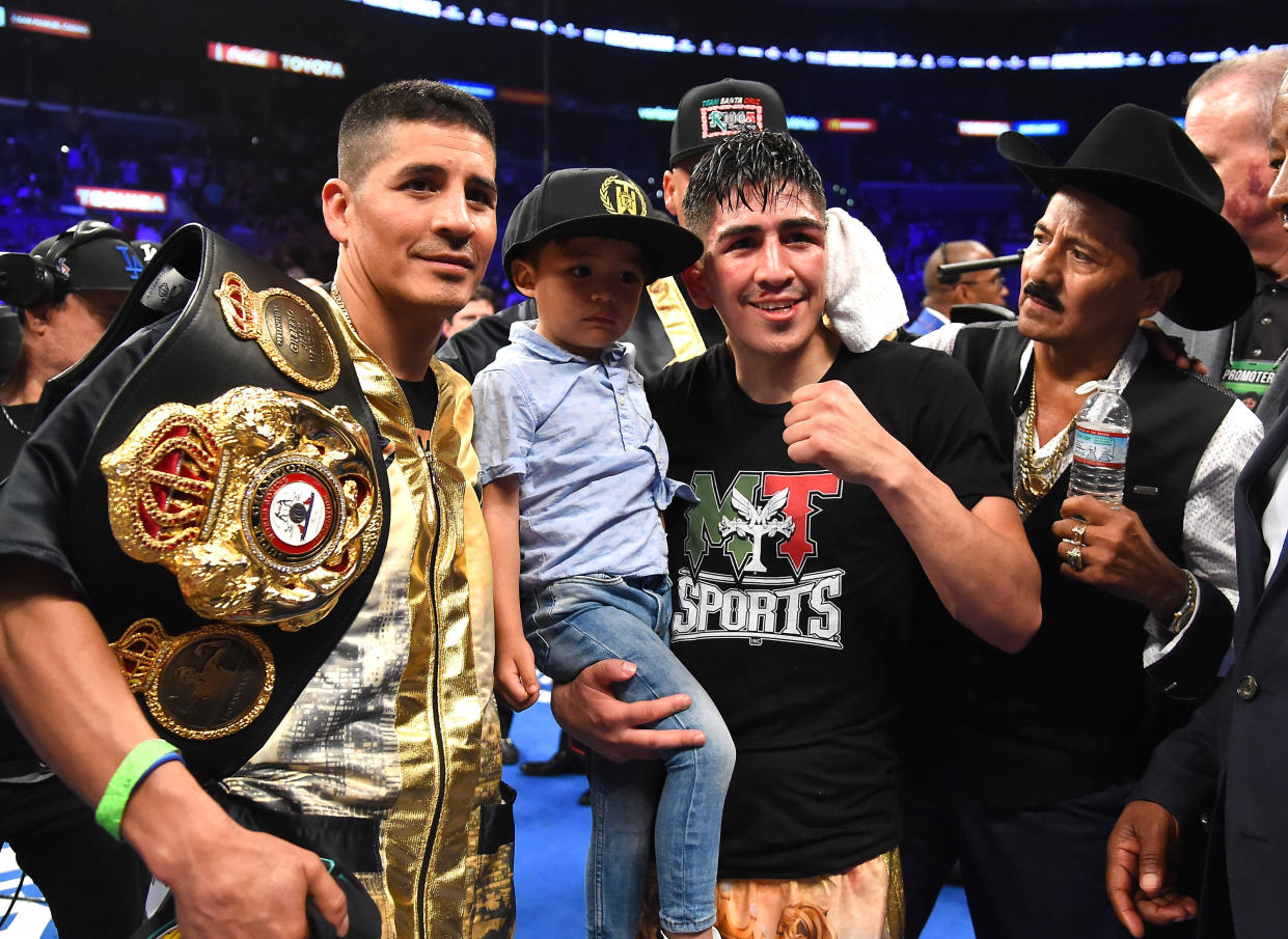 Antonio Santa Cruz (L), Leo Santa Cruz holding his son Al Santa Cruz and his dad Jose Santa Cruz (R) celebrate the defeat of Abner Mares (not pictured) at Staples Center on June 9, 2018 in Los Angeles, California. (Getty Images)