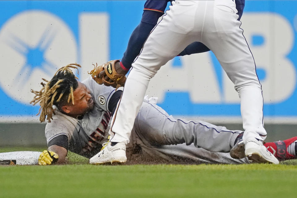 Cleveland Indians' Jose Ramirez lies on the base path after being tagged out, trying to stretch a single into a double, by Minnesota Twins shortstop Nick Gordon during first inning of a baseball game Wednesday, Sept. 15, 2021, in Minneapolis. (AP Photo/Jim Mone)