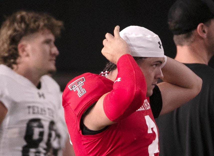 Texas Tech's Behren Morton puts on a cap during football practice, Tuesday, Aug. 8, 2023, at the Sports Performance Center.