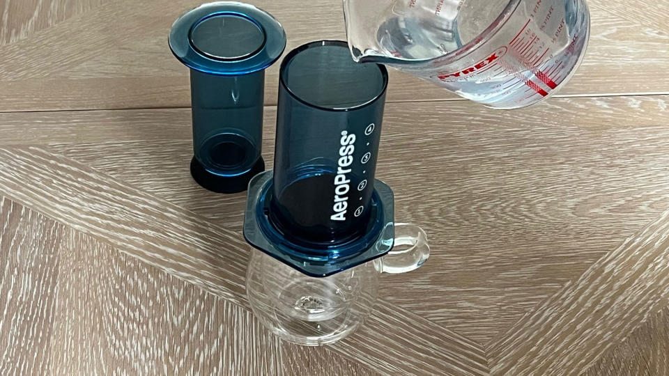 Water being poured into an AeroPress chamber