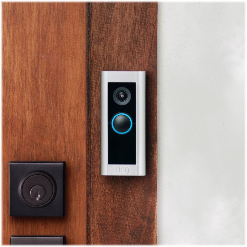 Ring Video Doorbell Pro 2 mounted on wooden door.