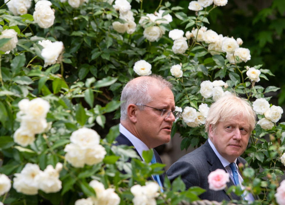 Britain's Prime Minister Boris Johnson looks at Australia's Prime Minister Scott Morrison as he speaks in the garden of 10 Downing Street in London, Britain, June 15, 2021. Dominic Lipinski/Pool via REUTERS