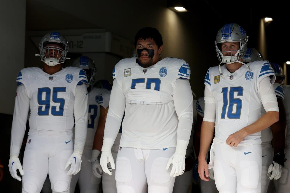 (From right) Lions quarterback Jared Goff, offensive lineman Penei Sewell and defensive lineman Romeo Okwara wait to run onto the field before the game against the Los Angeles Chargers on Sunday, Nov. 12, 2023, in Inglewood, California.