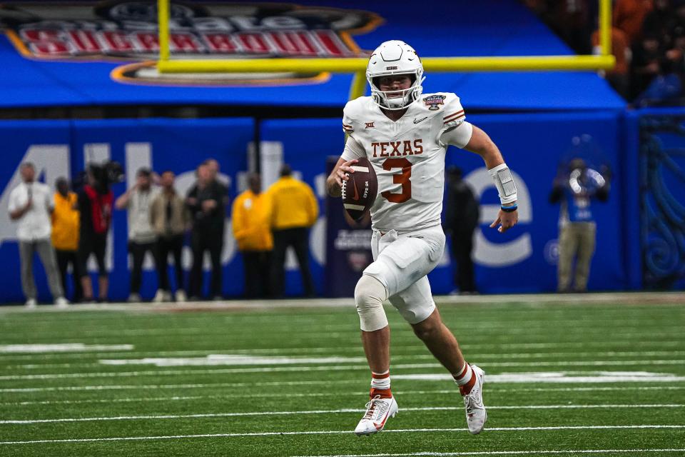 Texas Longhorns quarterback <a class="link " href="https://sports.yahoo.com/ncaaf/players/329235/" data-i13n="sec:content-canvas;subsec:anchor_text;elm:context_link" data-ylk="slk:Quinn Ewers;sec:content-canvas;subsec:anchor_text;elm:context_link;itc:0">Quinn Ewers</a> (3) runs the ball during the Sugar Bowl College Football Playoff semifinals game against the Washington Huskies at the Caesars Superdome on Monday, Jan. 1, 2024 in New Orleans, Louisiana.