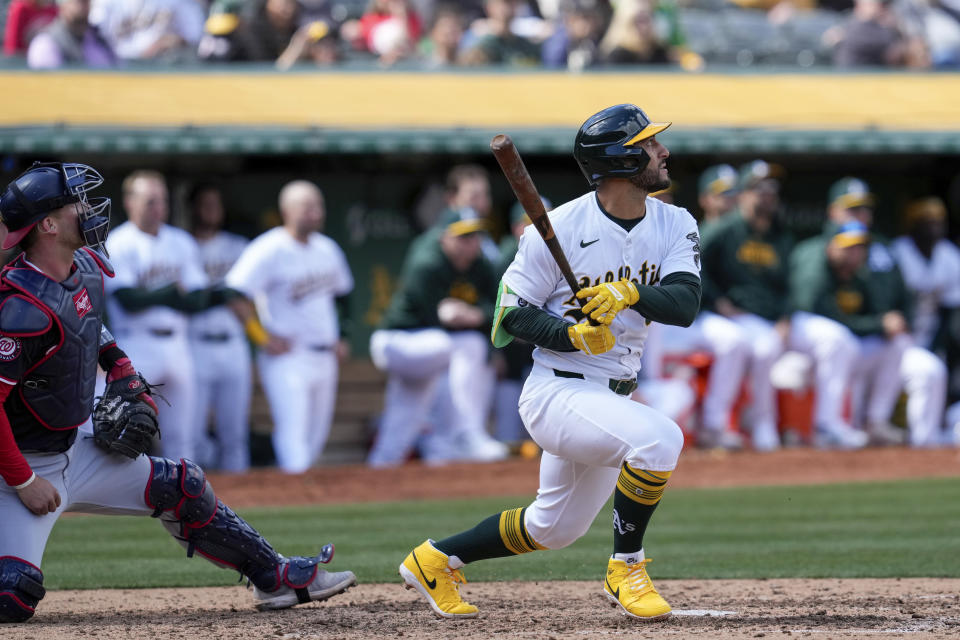 Oakland Athletics' Abraham Toro, right, watches his two-run single during the sixth inning of a baseball game against the Washington Nationals, Sunday, April 14, 2024, in Oakland, Calif. (AP Photo/Godofredo A. Vásquez)