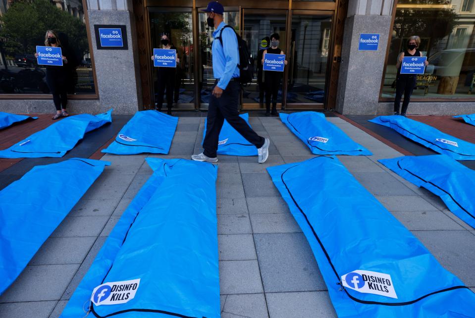 Someone walks through the bodybag demonstration outside Facebook headquarters in Washington, DC (Jim Bourg/Reuters)