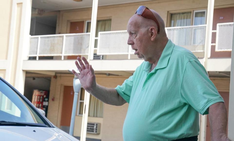 David Semrau waves goodbye to his friends, Diane Burrelsman and Chuck Wood, who had come to visit him Aug. 5 at the Town House Motel in Belleville, where’s he’s been staying since being evicted. Joshua Carter/jcarter@bnd.com