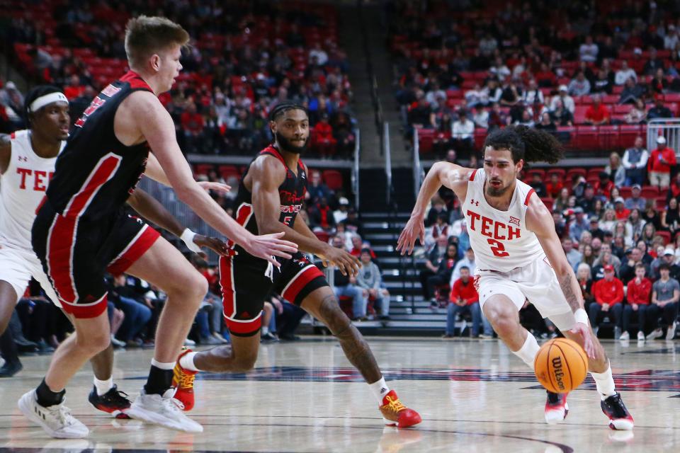 Dec 13, 2022; Lubbock, Texas, USA; Texas Tech Red Raiders guard Pop Isaacs (2) drives to the lane against Eastern Washington Eagles forward Dane Erikstrup (32) in the first half at United Supermarkets Arena. Mandatory Credit: Michael C. Johnson-USA TODAY Sports ORG XMIT: IMAGN-500888 ORIG FILE ID:  20221213_jcd_aj7_0149.JPG