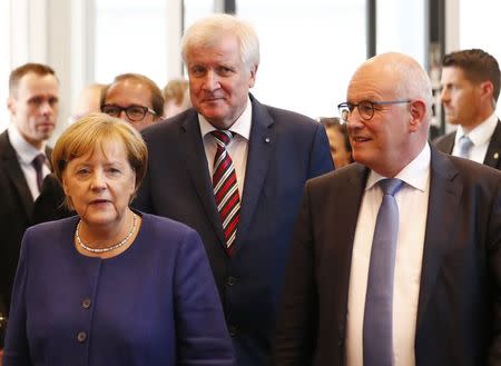 German Chancellor Angela Merkel (L to R) , leader of the Christian Democratic Union Party (CDU), Horst Seehofer, head of the CSU and Bavarian premier and Volker Kauder attend their first parliamentary meeting after the general election in Berlin, Germany September 26, 2017. REUTERS/Fabrizio Bensch